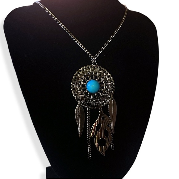 Silver-tone pendant with blue center and hanging feather accents - Picture 1 of 5